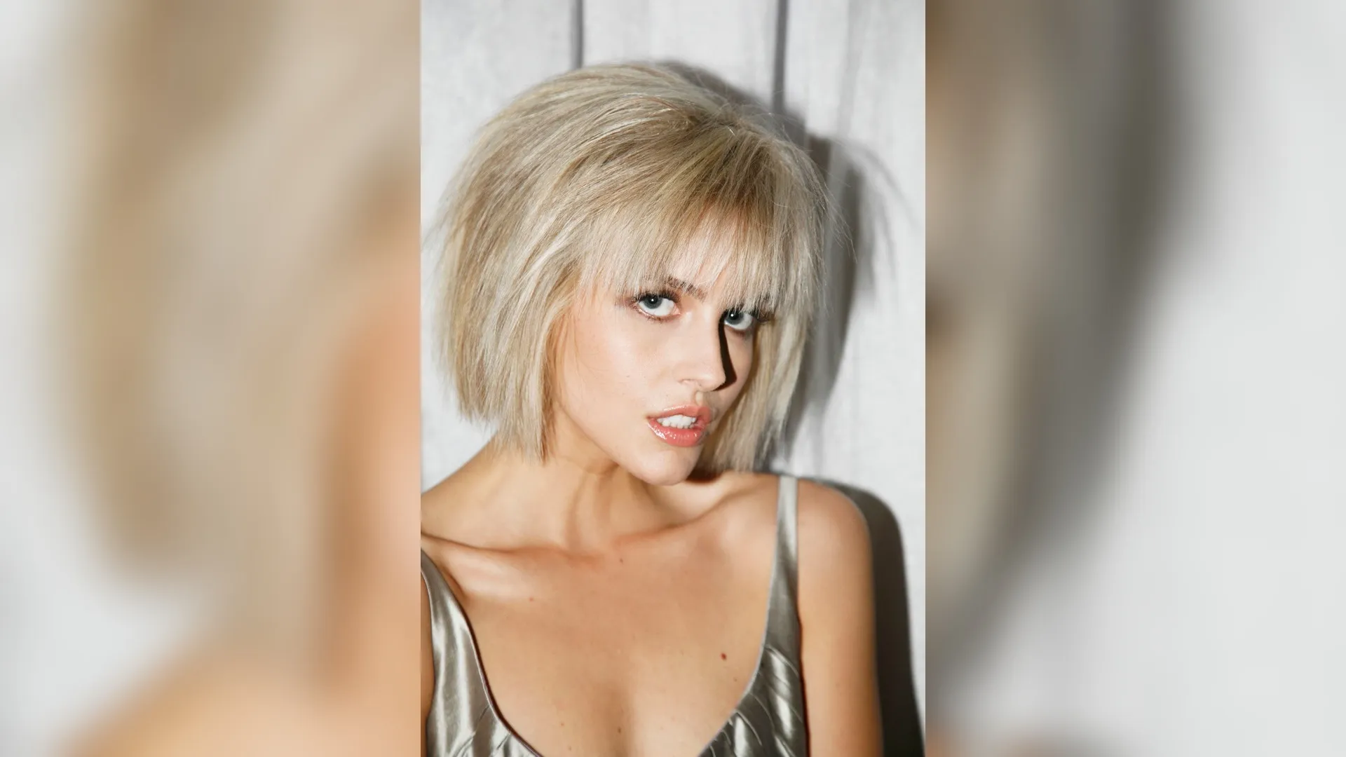 A woman with a short textured bob haircut featuring piecey separation at the ends, subtle movement, and a low-shine finish styled with matte pomade