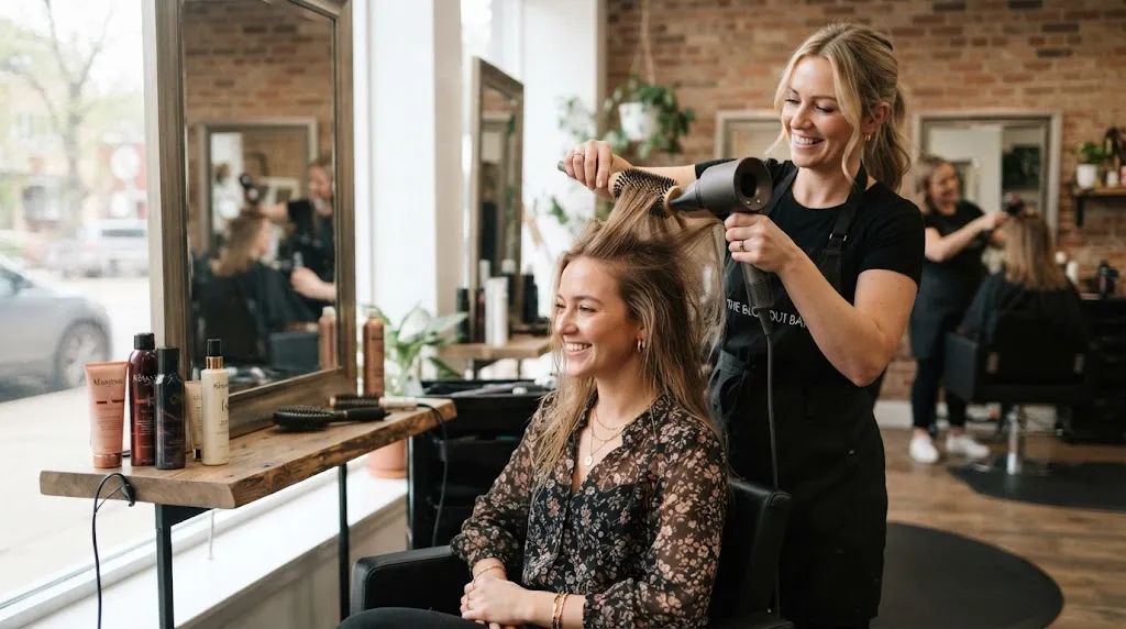 Stylist giving volume and root lift to fine hair in a modern salon setting